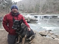 Man, German shepherd reported missing after officials find truck stuck on beach