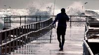 Hurricane Erin stirs up strong winds, floods part of main highway as it creeps along the East Coast