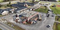 Drone video shows bus laying on Alabama high school gym after deadly tornado