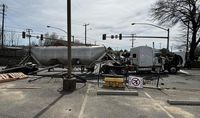 Tank truck flips over in downtown Hopewell, taking a traffic light with it