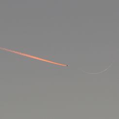 Jet Approaching a Crescent Moon