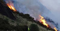 Firefighters in Scotland battle large brush fire on hill near Edinburgh