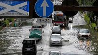 Heavy rain floods streets and halts air and rail travel in Tokyo