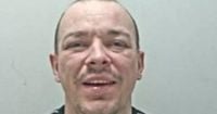 Prisoner on the run after escaping van and 'faking medical emergency'