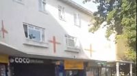Man arrested accused of racist abuse after flags painted on Essex buildings | LBC