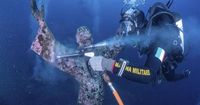 Italian divers water-blast the popular underwater statue of Christ off Portofino