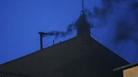Black smoke rises from the Sistine Chapel as cardinals cast an unsuccessful first vote
