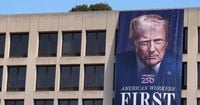 Trump hangs giant 'glorious leader' flag with his own face on federal buildings