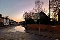 Frustration after blocked drains caused persistent flooding on main road