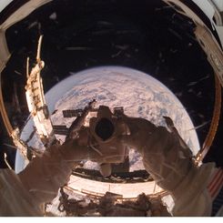 Orbiting Astronaut Reflects Earth