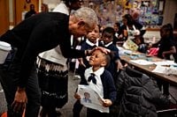 Barack Obama visits Chicago to check on his center’s progress — and makes a surprise school visit