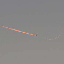 Jet Approaching a Crescent Moon