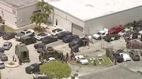 Three shot at car dealership as masked man with rifle storms business