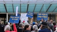 Grassroots Iowa City town hall erupts into rally against federal layoffs, funding cuts