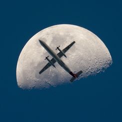 An Airplane in Front of the Moon