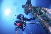 Italian divers water-blast the popular underwater statue of Christ off Portofino