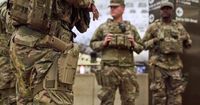 Photos of week three of Washington's federal takeover, as troops on patrol start carrying guns