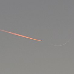Jet Approaching a Crescent Moon