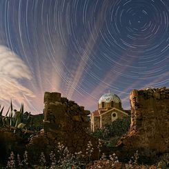 Illuminated Cloud Trails Above Greece