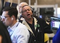 Wall Street holds near its records following the latest report showing the US job market is slowing