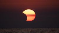 Where will the partial solar eclipse be visible tomorrow?