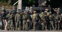 Children yanked from beds and zip-tied as 300 ICE agents raid apartment complex